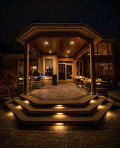 Dramatic outdoor patio area with concrete steps and elegant lighting in Westlake, Ohio